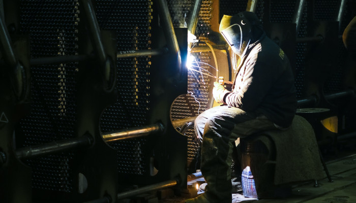 Precision Maintenance Solutions technician welding on site
